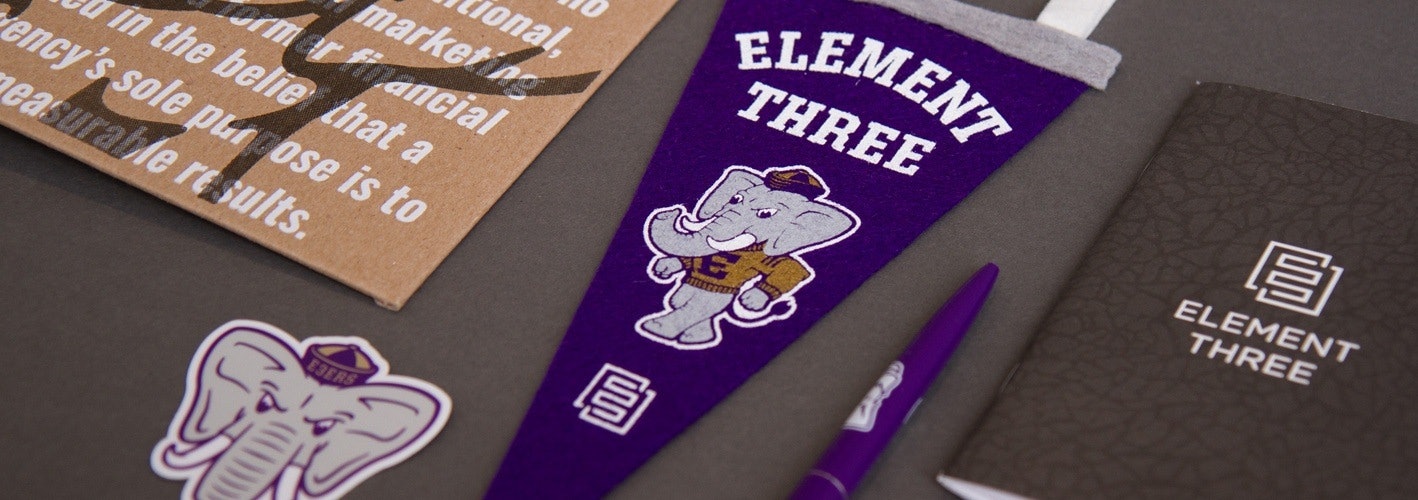Assorted Element Three branded swag such as a pennant, notebook and more